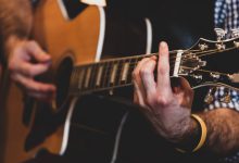 close up of hands playing classic guitar selective focus