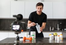 excited young man filming his video blog episode